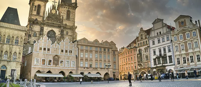 Prague city skyline featuring Charles Bridge and historic buildings along the Vltava River in the Czech Republic.